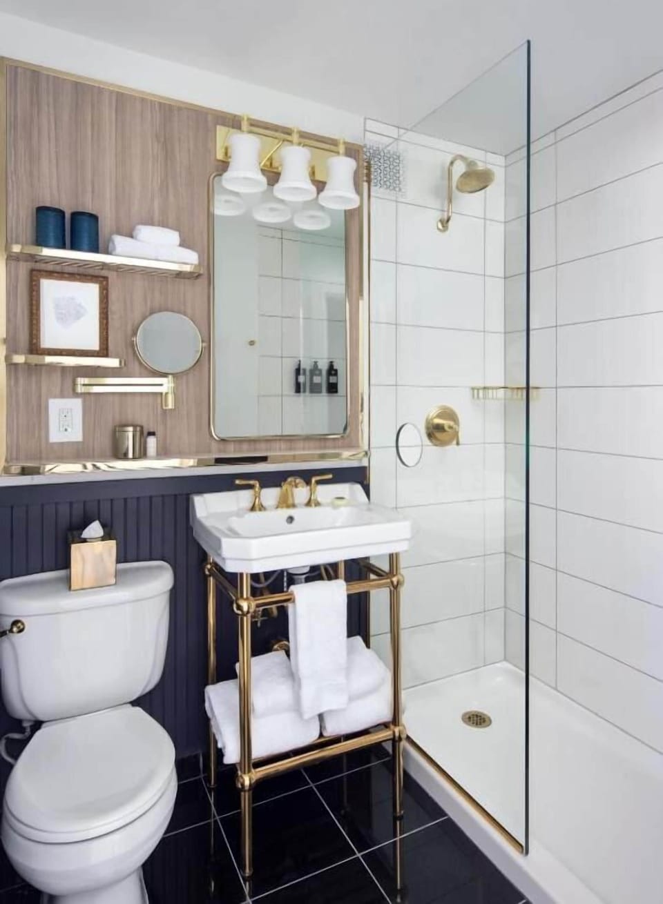Refresh in a sleek, glass-walled shower with polished brass accents.