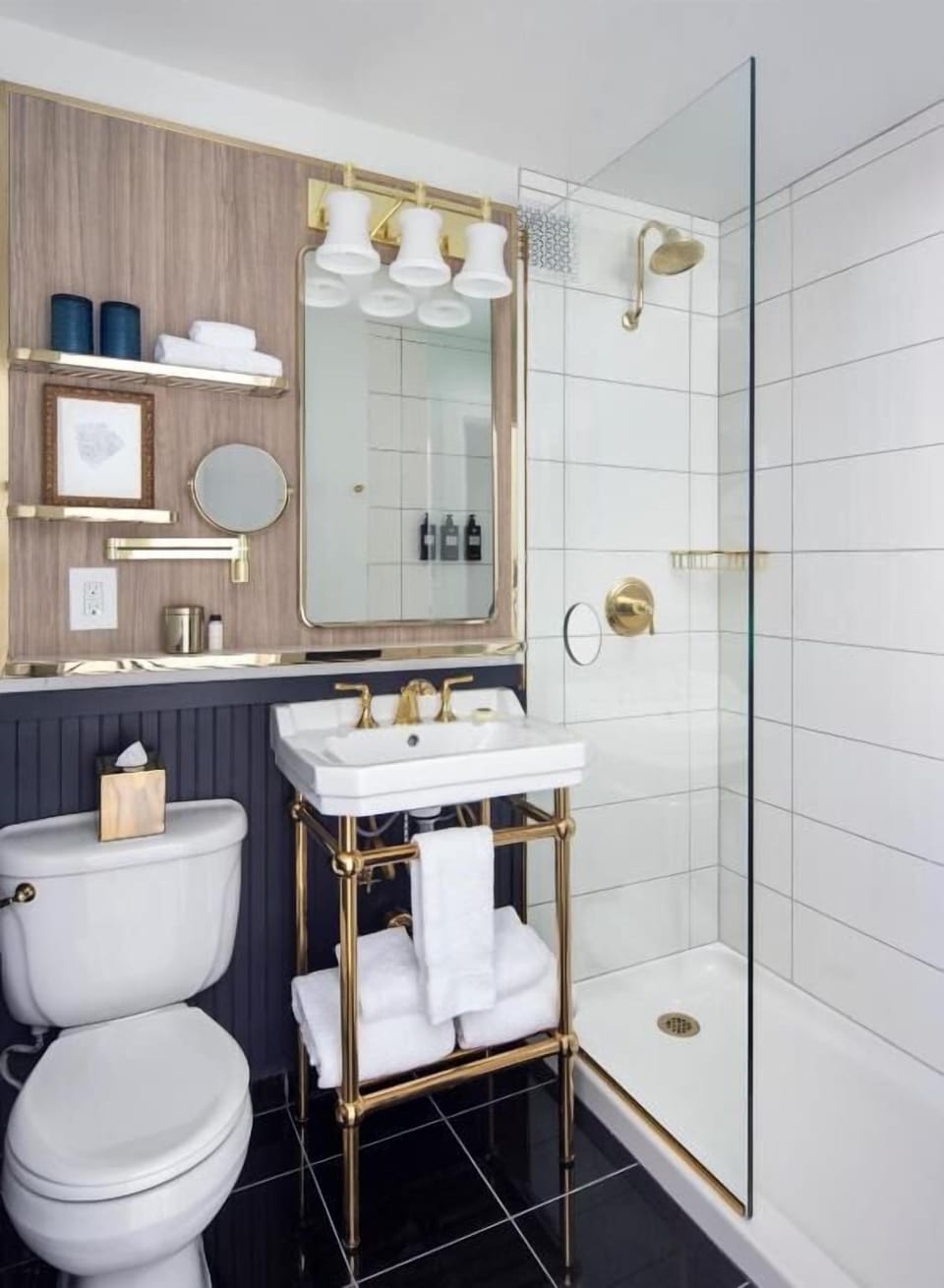 Refresh in a sleek, glass-walled shower with polished brass accents.