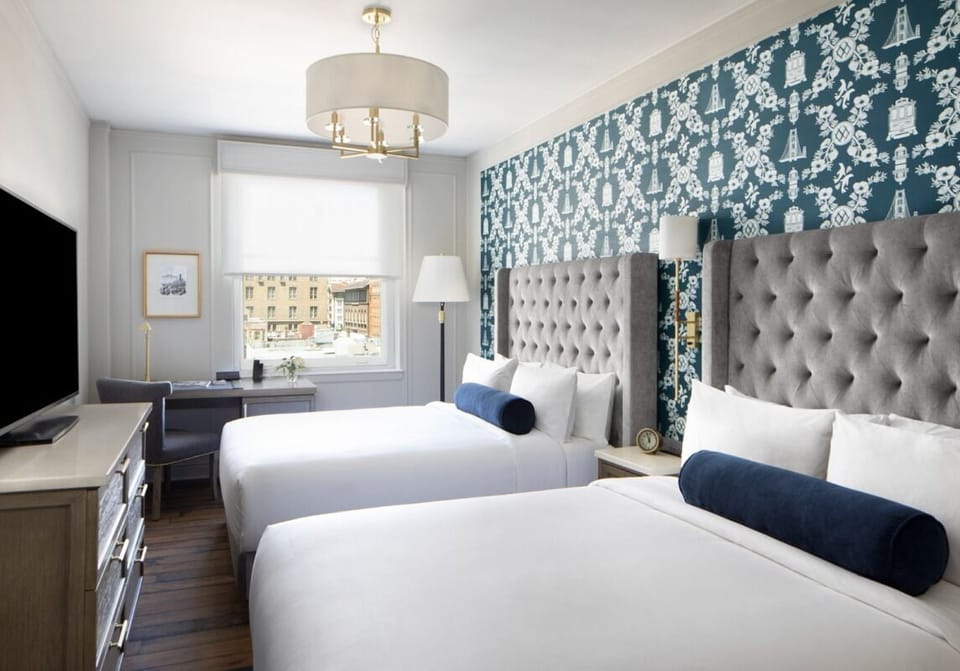 Stretch out after exploring, enjoying crisp linens and city views.