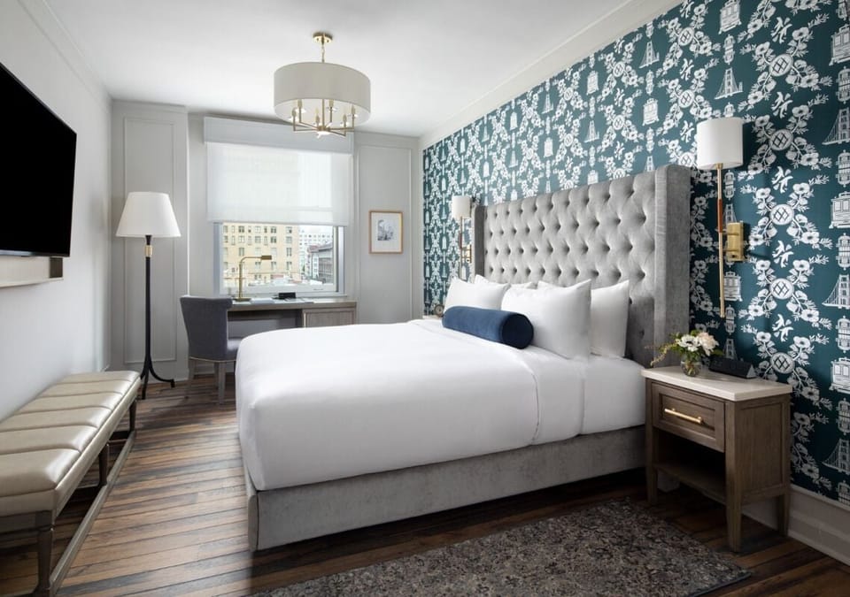 Relax in a bright bedroom with bold patterned accent wall.