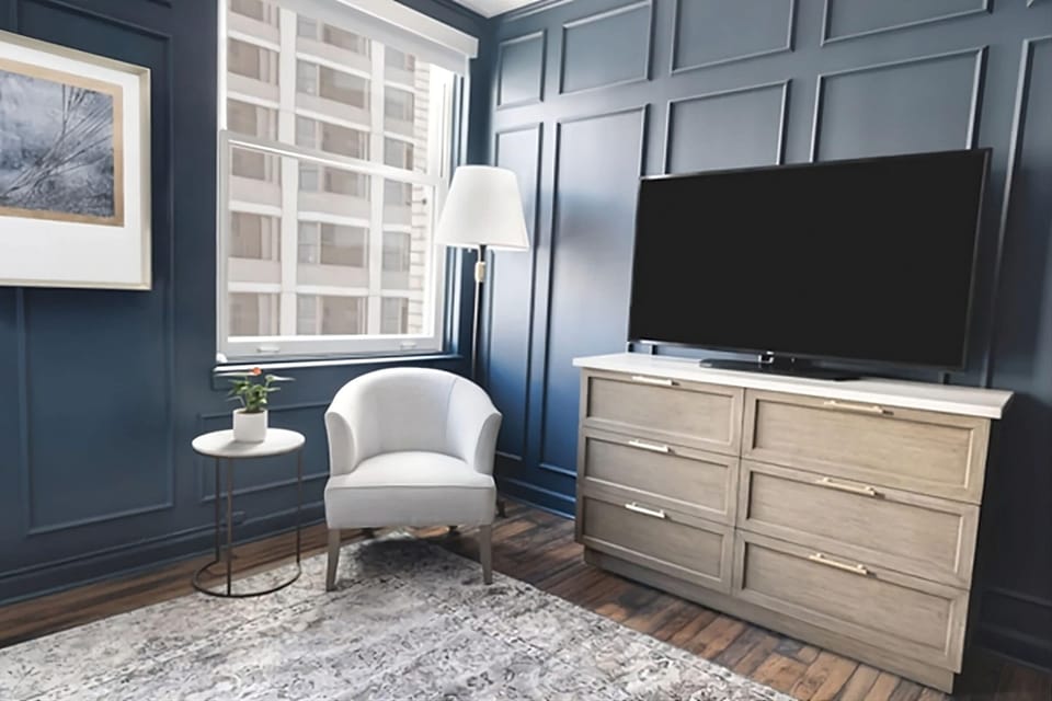 Unwind by the window with lounge chair and in-room TV.