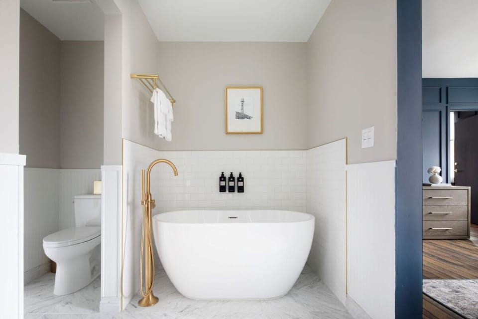 Rinse off in a bright, modern bath with fluffy towels ready.