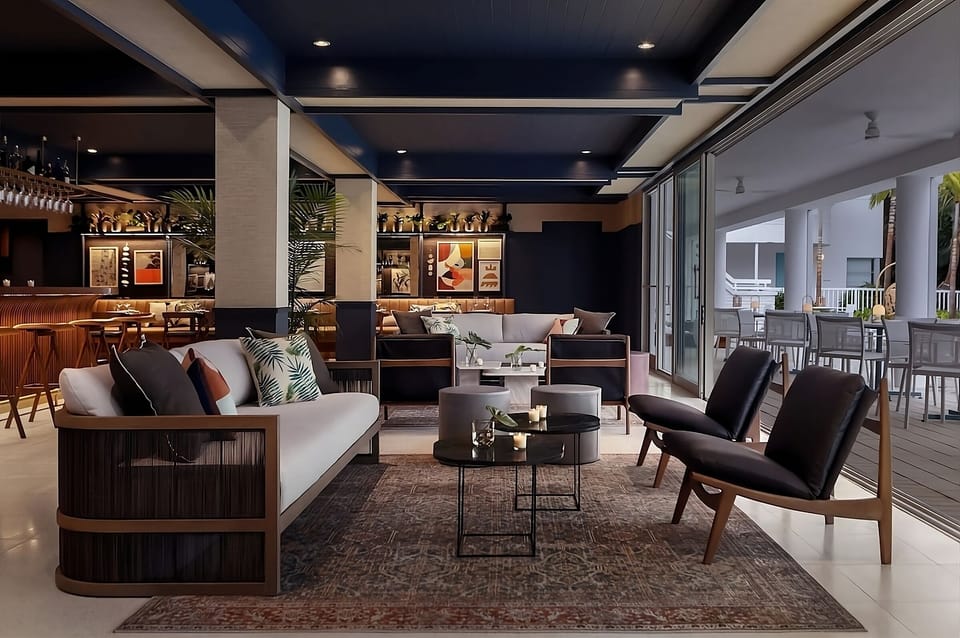Unwind on plush sofas with breezy terrace views beside you.