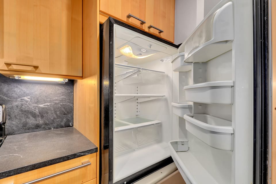 Open fridge interior w/ adjustable shelving for easy food storage