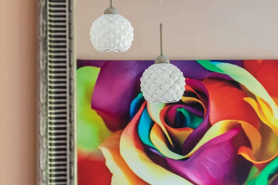 A vibrant close-up of the rainbow-colored wall art in the bedroom, adding a playful and modern touch to the decor.

