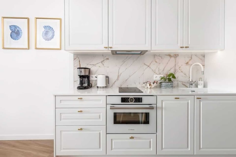 Another perspective of the kitchen, highlighting its clean design, bright lighting, and practical workspace.

