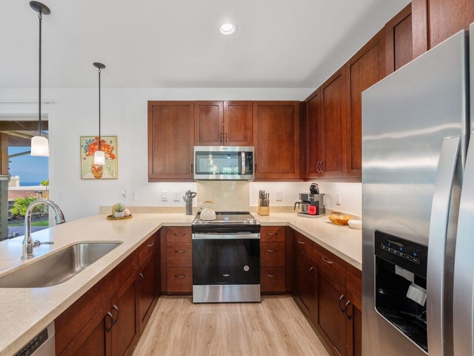 Fully equipped kitchen with all appliances, dinnerware, silverware, kitchen utensils, and cooking pans/pots.