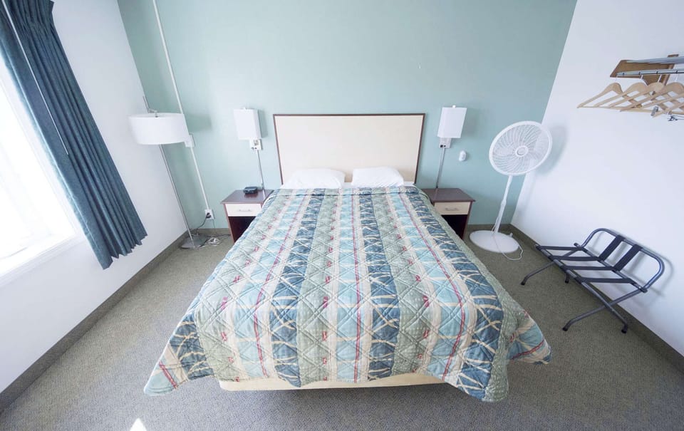 Bright bedroom with double bed, window and nightstand