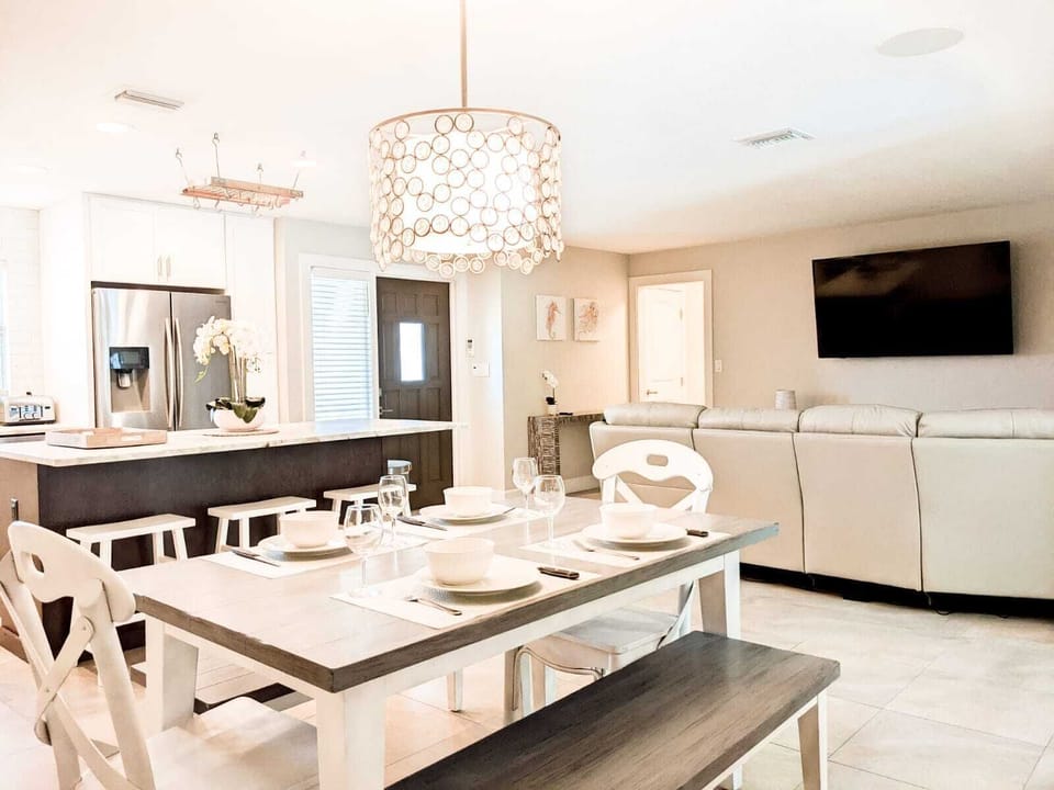 Open-concept Living room and dining area with TV.