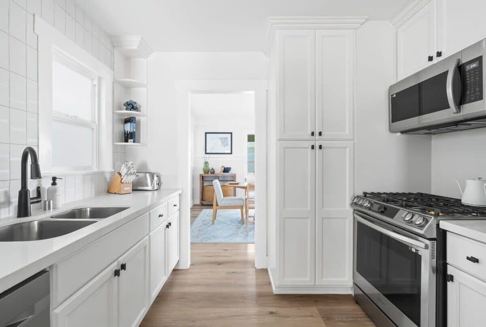 The home's sleek and modern kitchen features top-of-the-line appliances and fixtures, providing a beautiful and functional space for cooking and dining.