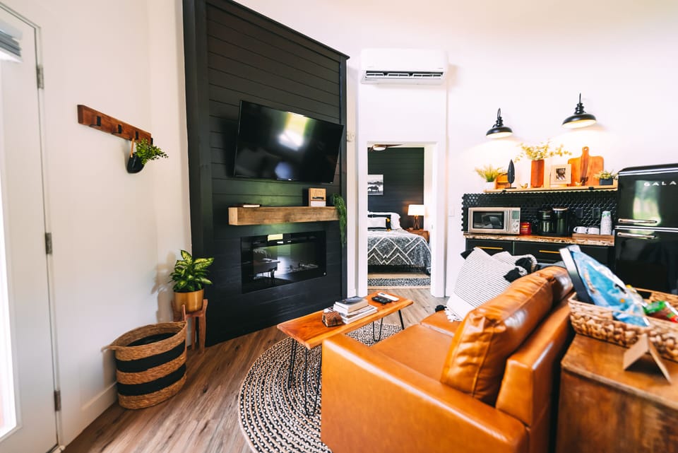 Closup of Back of Loveseat, Fireplace, TV, looking toward Queen Bedroom - The Silo Cottage