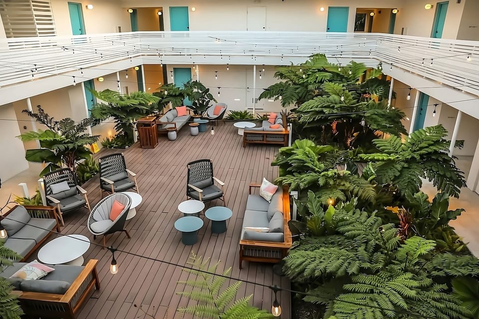 Gather under string lights in a lush, social courtyard.