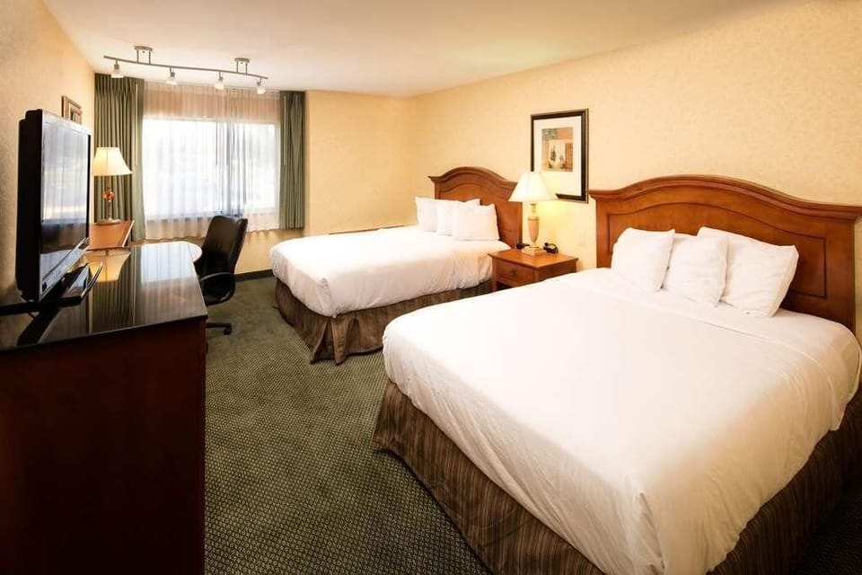 Arrive and relax in a roomy double-queen setup with TV.