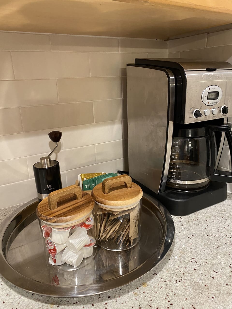 Amenities such as ground coffee, coffee grinder, creamer and sugar provided.
