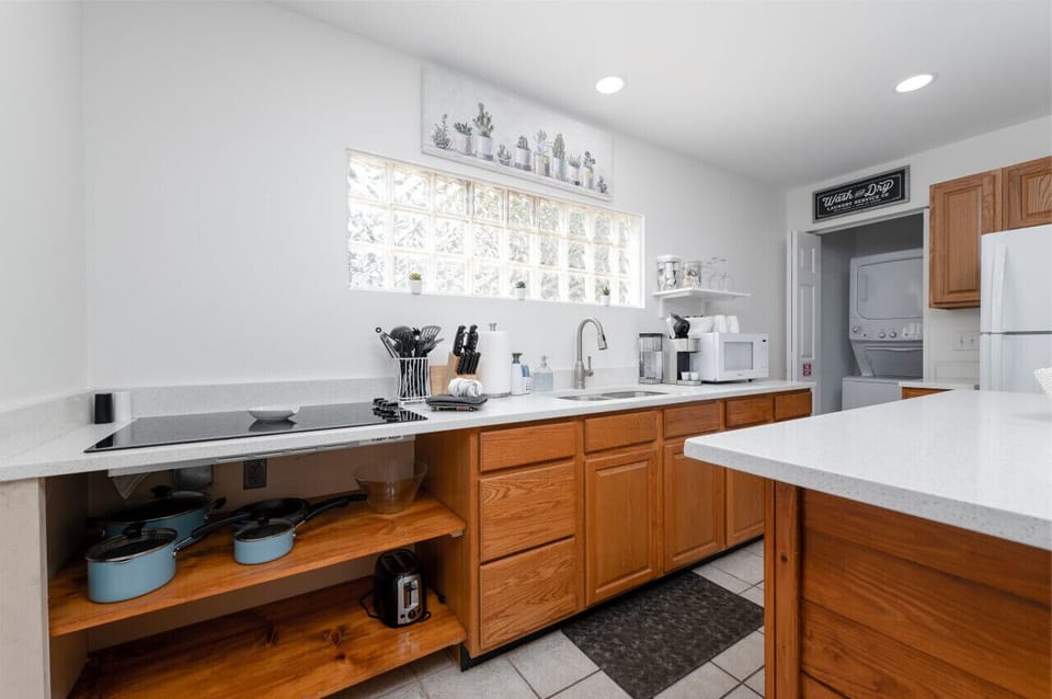 Kitchen is fully equipped with stove top, toaster oven, toaster, microwave, coffee maker, pots & pans, and cooking utencils