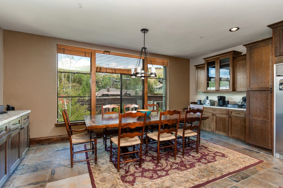 - Share family meals or game night laughter at this scenic eight seat dining table
- Soak in the mountain views through wall to wall windows as sunlight pours in
- Coffee station and toaster setup nearby for easy mornings and cozy evenings