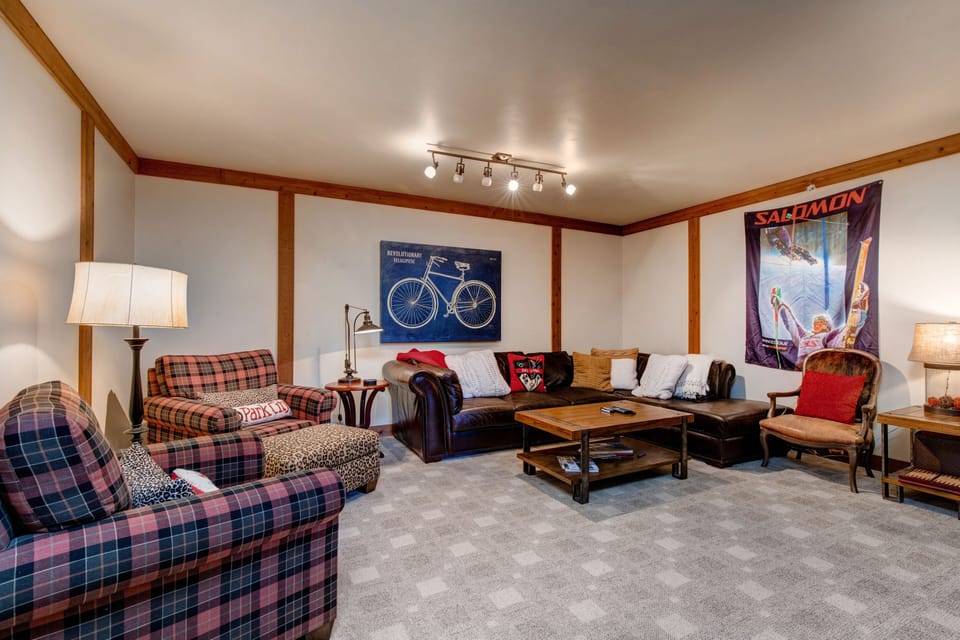 - Stretch out on the leather couch or curl up in plaid armchairs with a good book
- Fun vintage touches like ski art and bicycle prints set the cozy mountain mood
- Ideal for movie nights, card games, or lazy mornings with coffee in hand