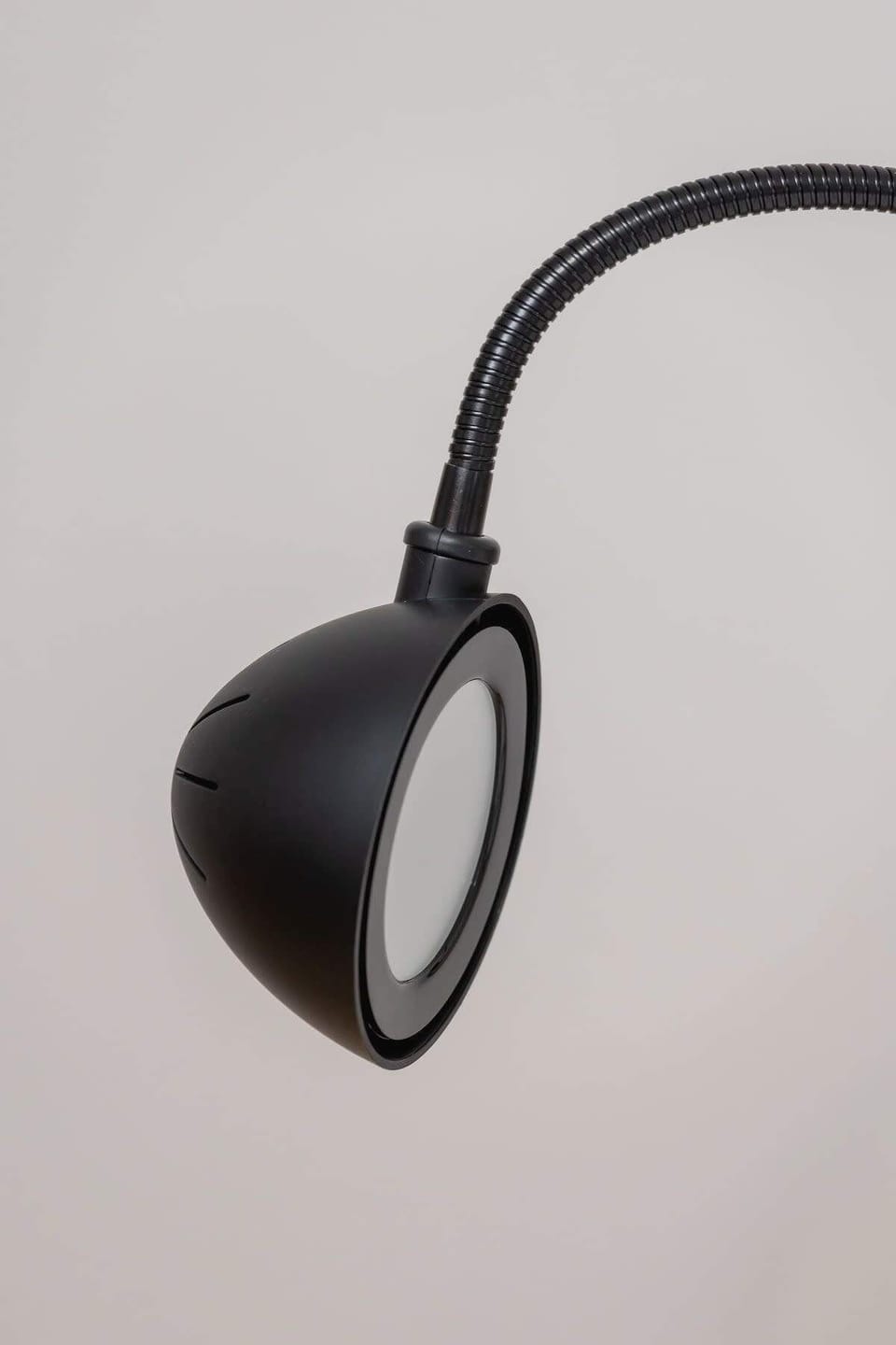 A close-up of a modern black wall lamp, adding a sleek and functional lighting solution to the space.






