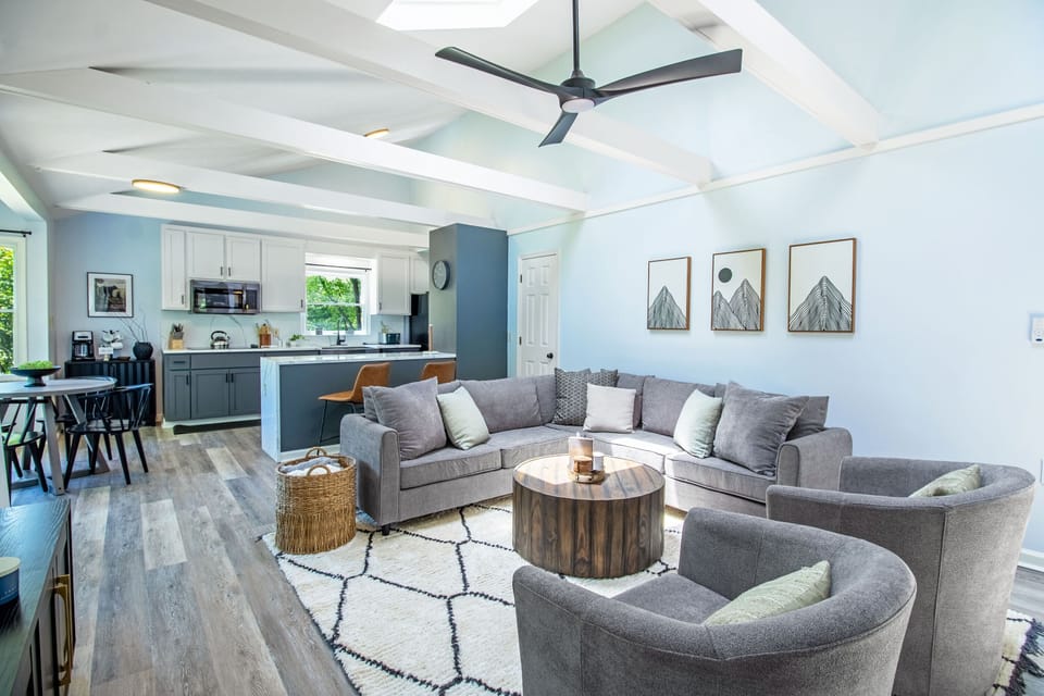 Living area with lounge seating, television, fireplace, and skylights