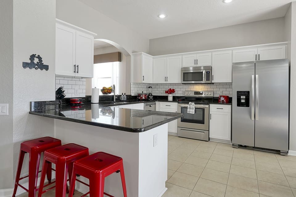 The fully equipped kitchen features stainless steel appliances and beautiful upgraded cabinets.