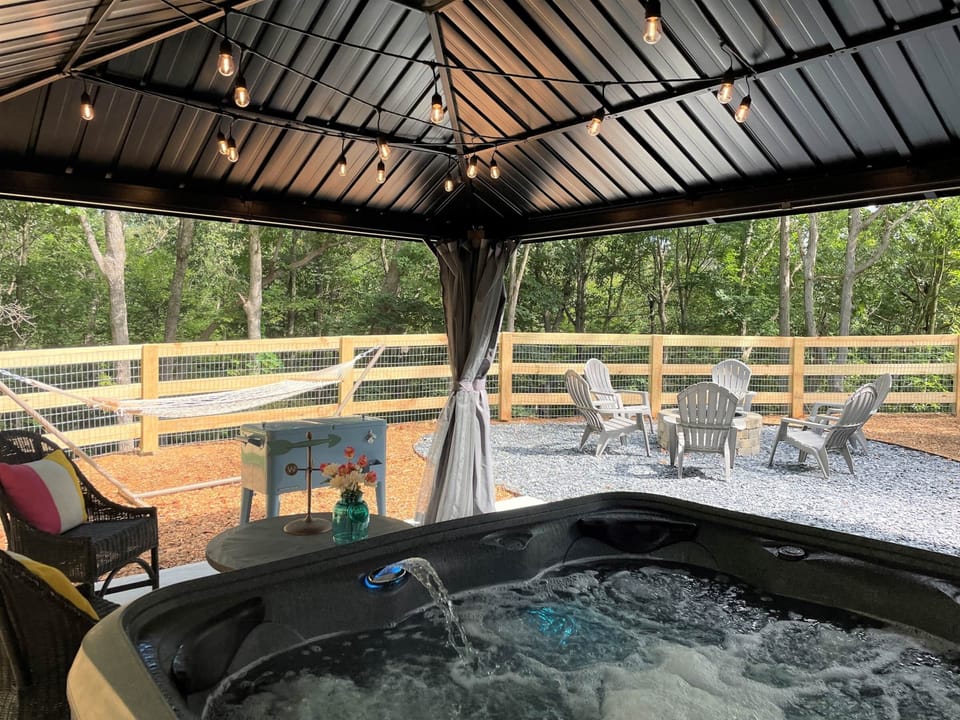Covered hot tub with cafe lights for evenings