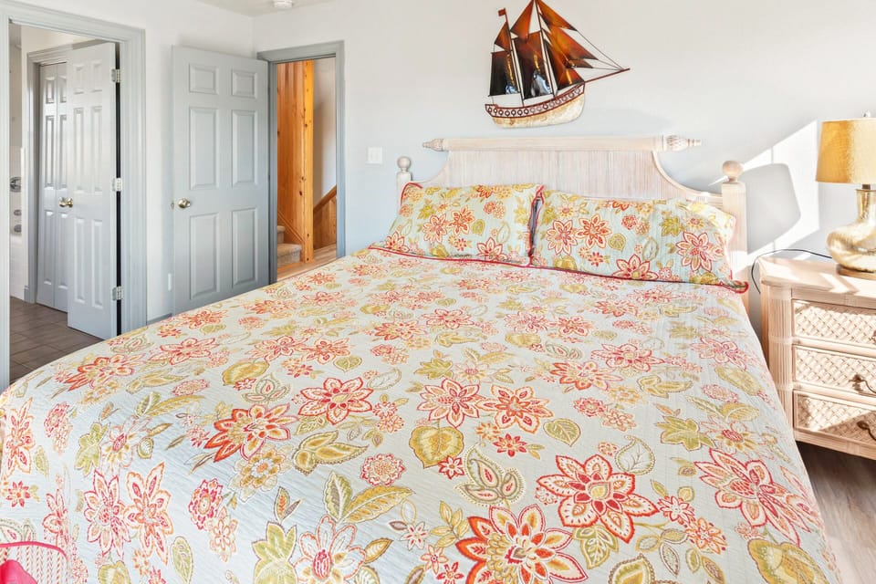 Get some rest in the Mid-level Queen Bedroom w/ Private Bathroom and Deck Access.