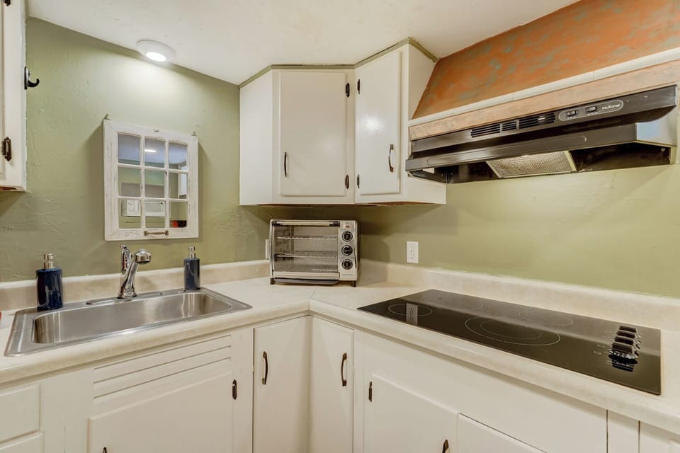 Toaster oven, sink, cabinets and range