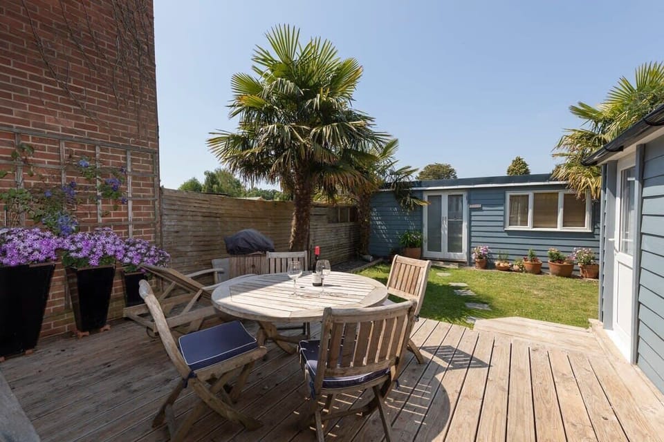The decking in the garden sits the garden dining furniture.