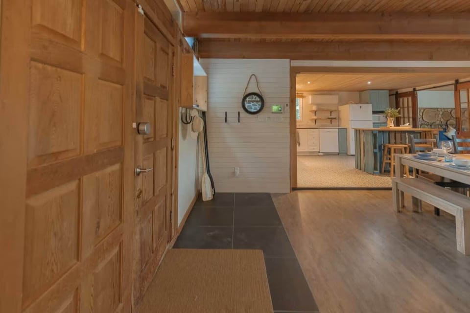 Entrance hallway leading into a spacious kitchen and dining area with warm wood finishes