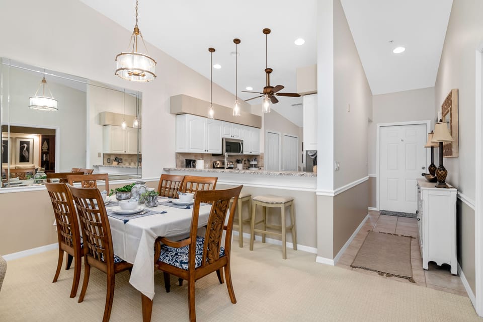 Formal dining table in addition to four barstools and eat-in kitchen.