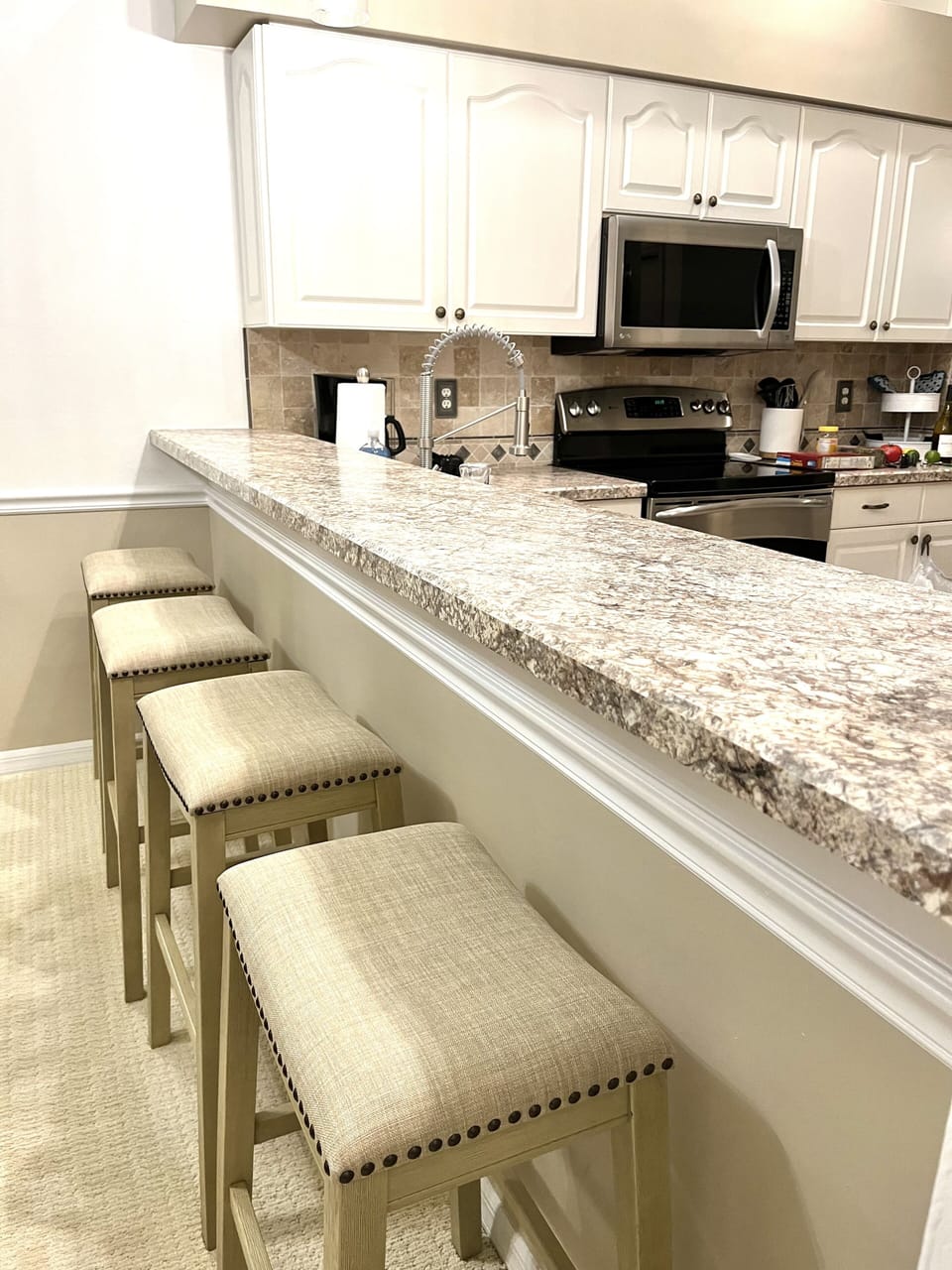 Four new barstools at the kitchen counter.