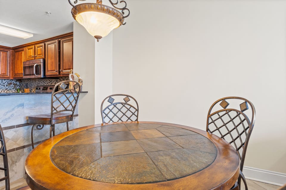 Dining Area - This inviting dining area seats four comfortably, offering a stylish setting to relish homemade dishes with a picturesque beach view. Includes 2 bar stool for extra seating.