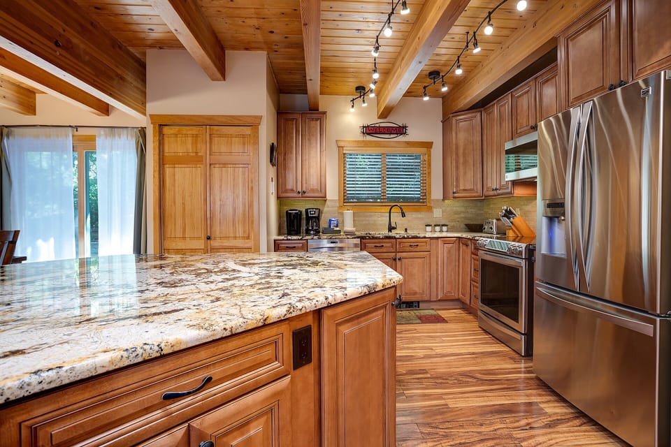 Your gourmet kitchen awaits with gleaming granite counters, rich wood cabinets, and professional appliances perfect for creating memorable meals.