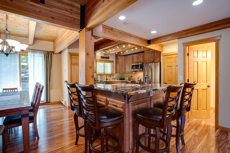Your spacious kitchen features warm wood beams, granite island seating, and everything needed for memorable meals together.