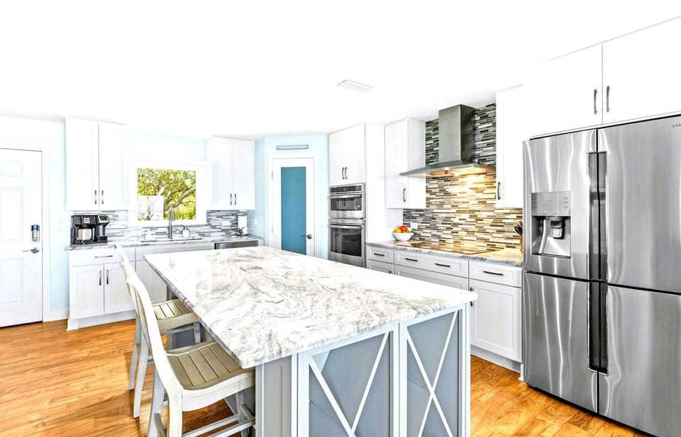 Kitchen with center island and two barstools