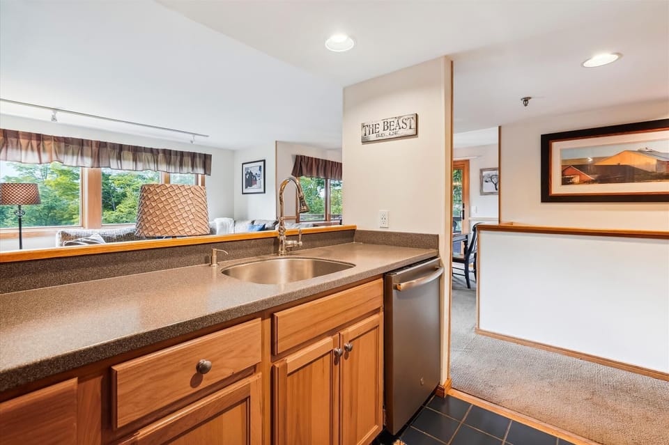 Modern kitchen with ample counter space, stainless appliances, and an open pass-through to the main living area.