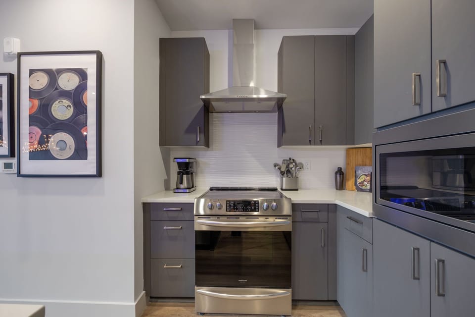 Fully equipped kitchen featuring stainless-steel appliances and stocked with culinary essentials for ease and convenience during your stay.
