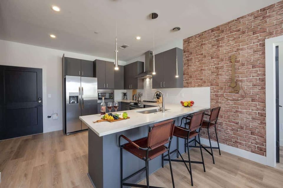 Experience the joy of cooking in a fully equipped kitchen with top-tier stainless steel appliances, sleek granite countertops, and cozy breakfast bar seating.