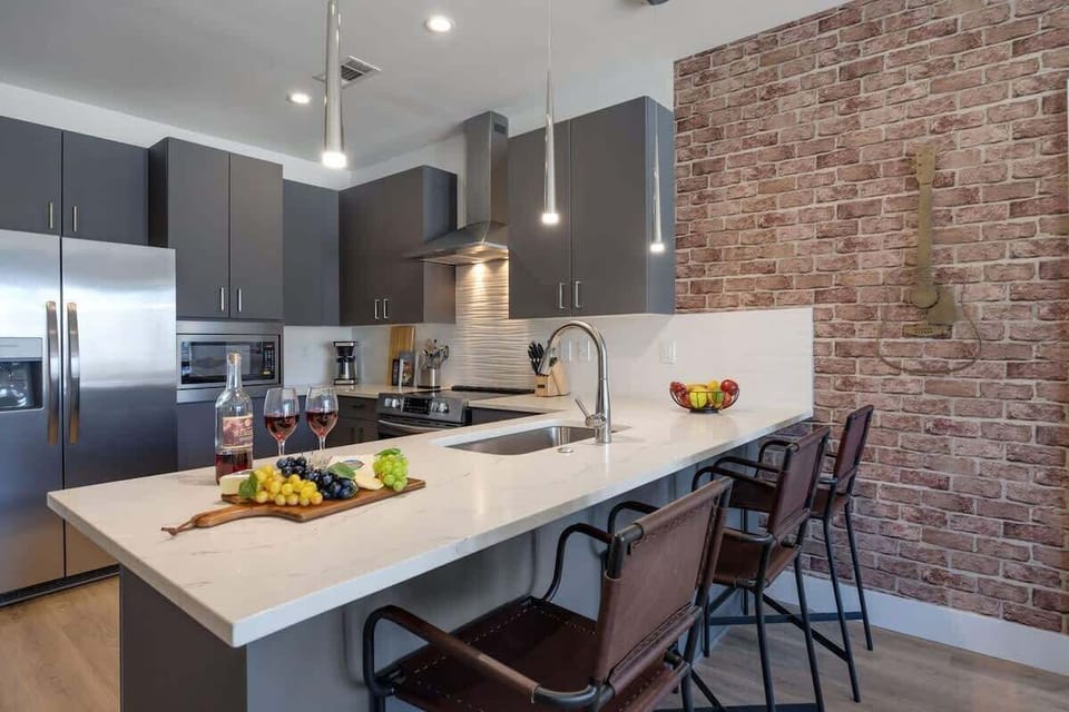 Experience the joy of cooking in a fully equipped kitchen with top-tier stainless steel appliances, sleek granite countertops, and cozy breakfast bar seating.