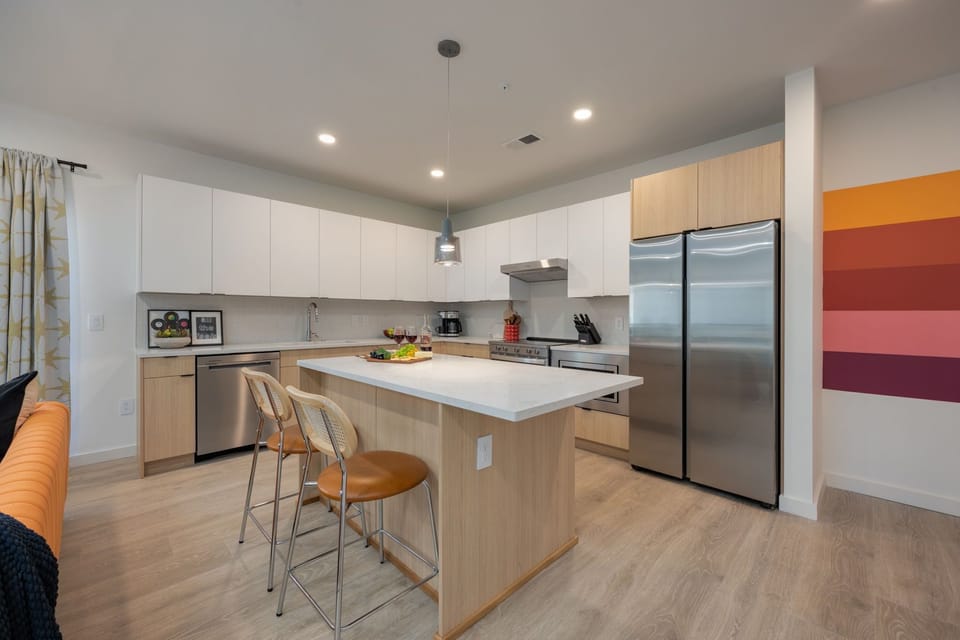 Fully equipped modern kitchen with stainless steel appliances and basic cooking essentials.
