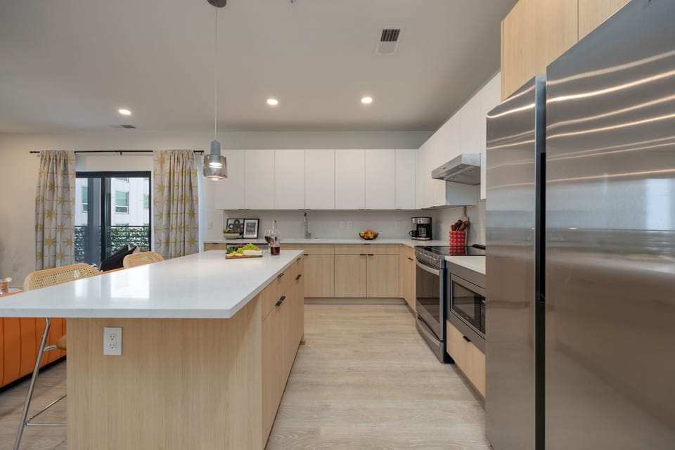 Fully equipped modern kitchen with stainless steel appliances and basic cooking essentials.