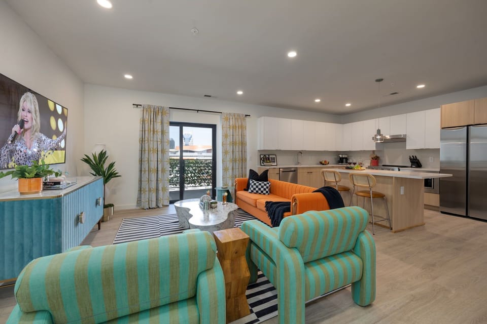 Spacious open floor plan with funky Andy Warhol inspired designer decor featuring multiple seating, smart TV, and access to private patio.