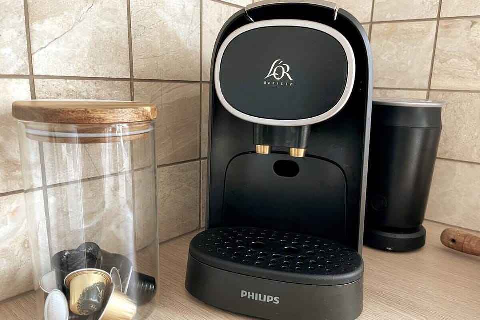 Nespresso coffee pod machine with frother.