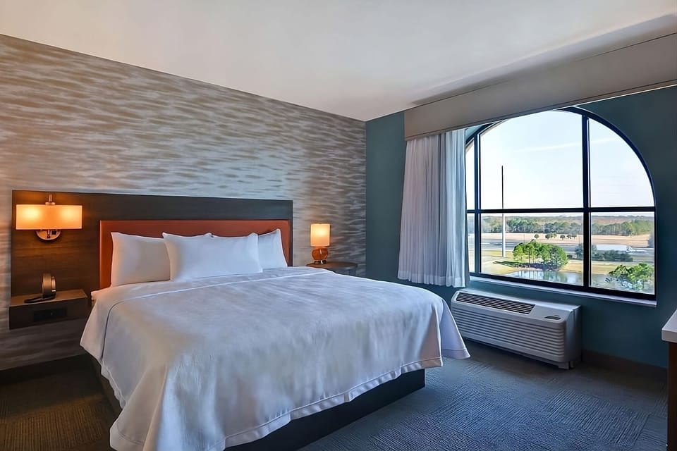 Wake up to sweeping views through a dramatic arched window.