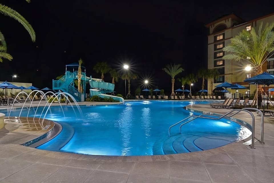 Dive into a glowing lagoon pool under starry skies.