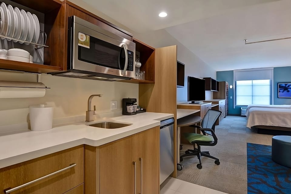 Prep quick bites with microwave, sink, and handy dishware storage.