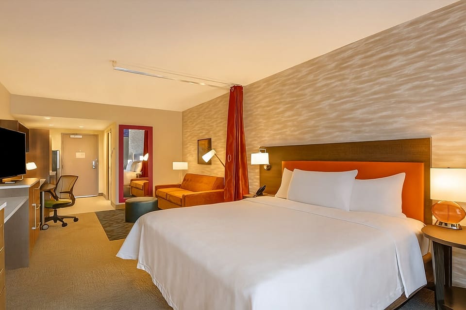 Settle into a spacious room with desk, sofa, and glow.
