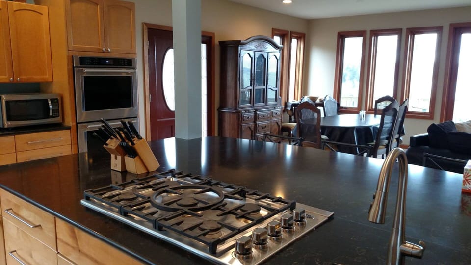 Featuring dual ovens, a 5-burner stovetop, and a pair of sinks for all your culinary needs.