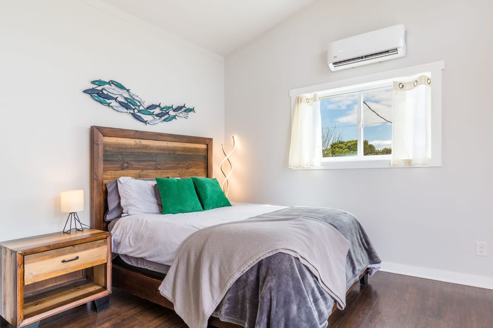 Primary bedroom features a queen bed and deck access.