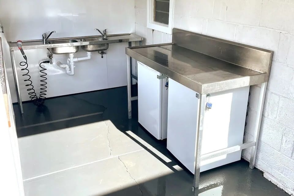 Communal fish cleaning station with outdoor freezers to keep bait and catches. 